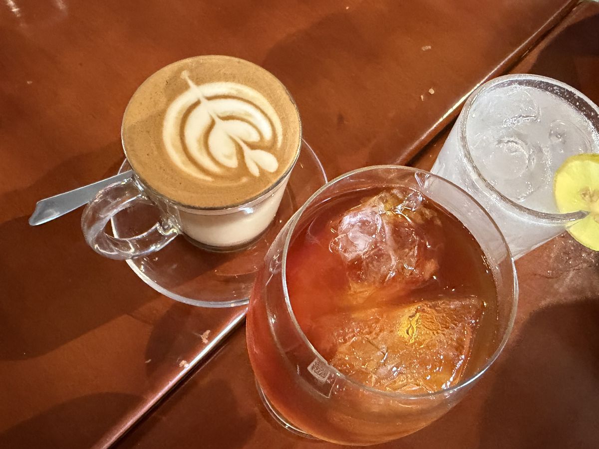 Cappuccino with latte art and an iced cold brew at Chelvies